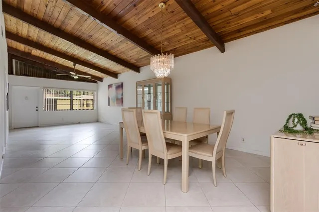 a dining room with furniture and a kitchen view