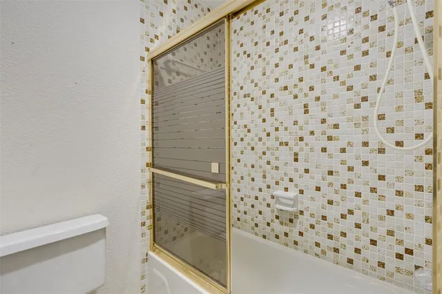 an empty room with closet and windows