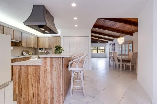 a kitchen with a stove sink and cabinets