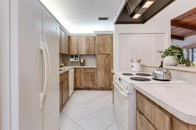 a kitchen with a white cabinets and white appliances