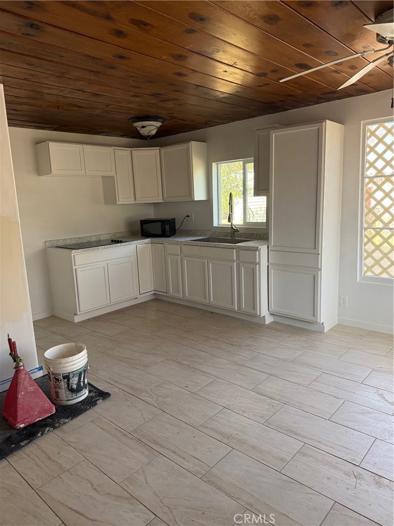 16100 Navajo Road Apple Valley, CA 92307 - Photo 47 of 55 a kitchen with a sink and cabinets
