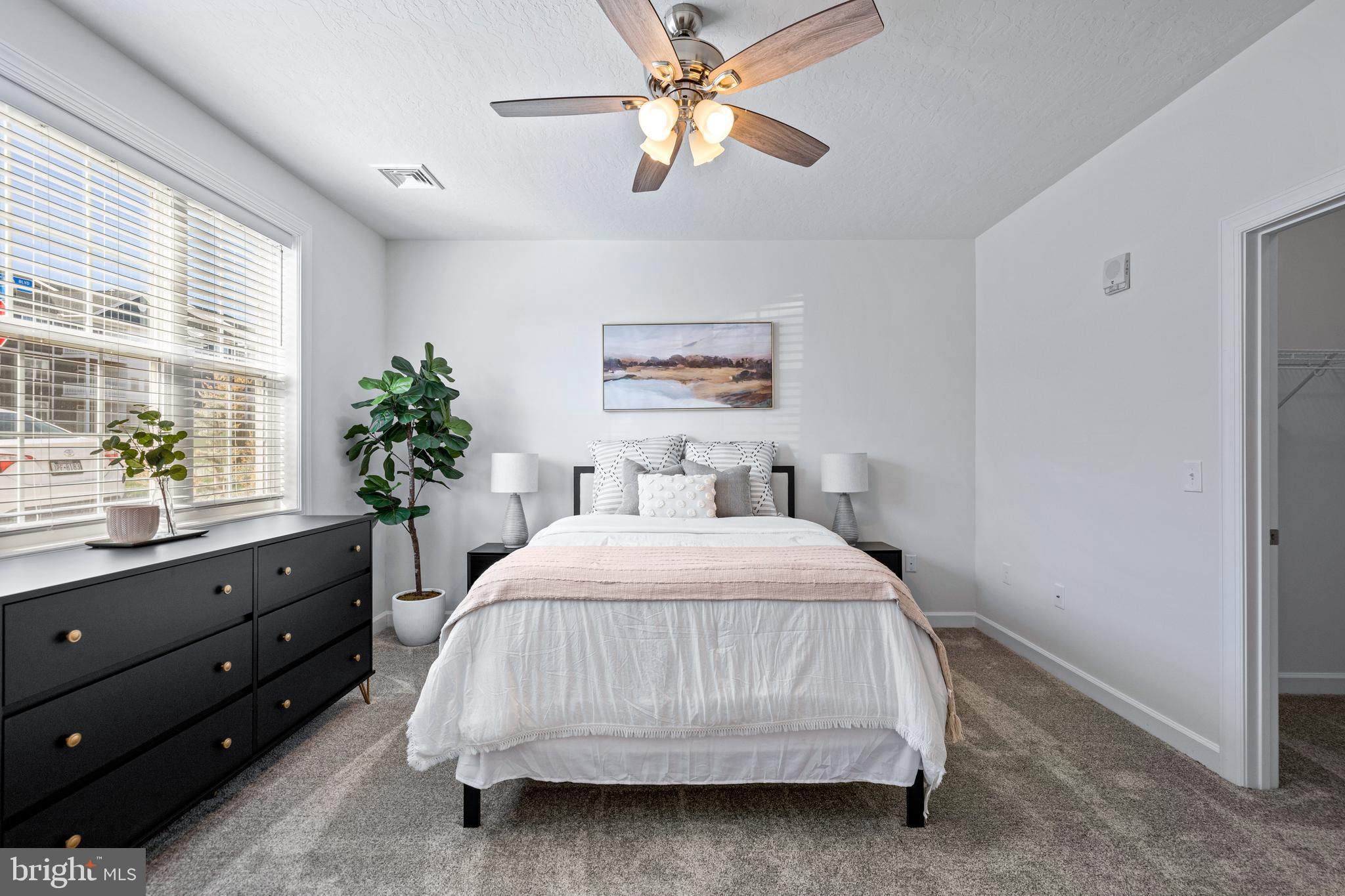 1010 Admiral Lane, Unit 201 Hanover, PA 17331 - Photo 24 of 36 a bedroom with a bed and a potted plant