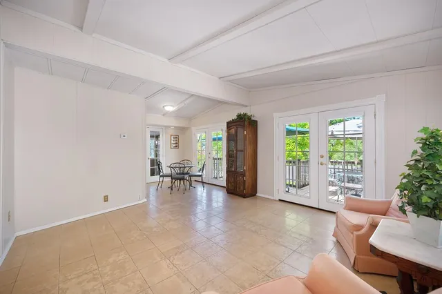a view of a livingroom with furniture and floor to ceiling window