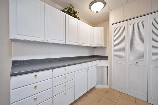 a kitchen with white cabinets and a sink
