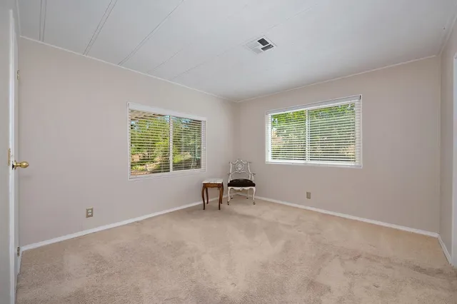 a view of room with a window and a chair