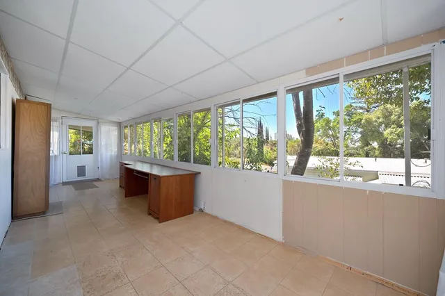 a room with furniture and large windows