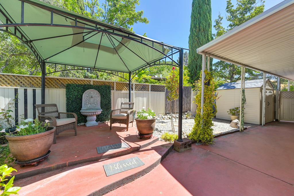 6374 Brodie Drive Newcastle, CA 95658 - Photo 40 of 50 a view of a patio with table and chairs under an umbrella