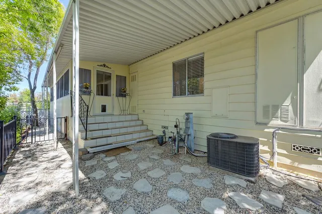 a view of a porch with chairs and backyard
