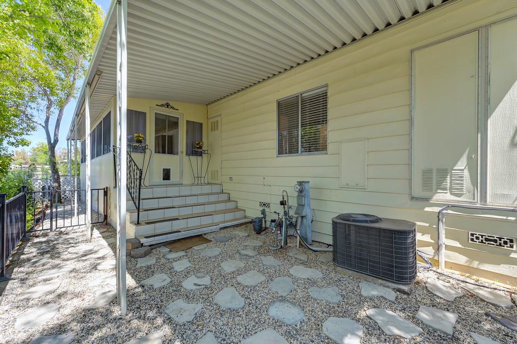 6374 Brodie Drive Newcastle, CA 95658 - Photo 46 of 50 a view of a patio with table and chairs and wooden fence