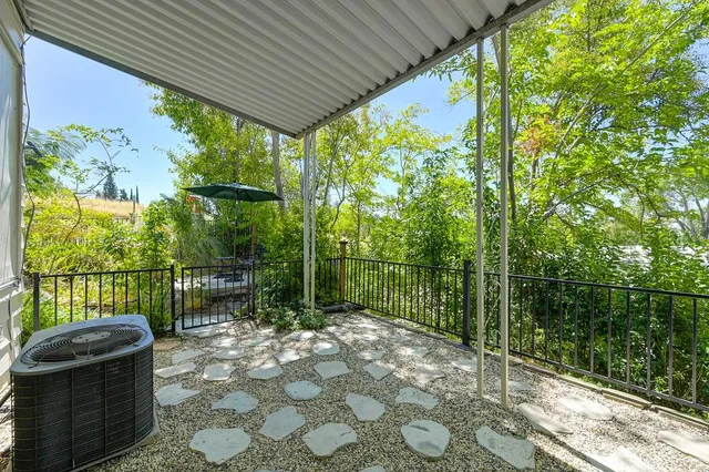 a view of a chair and table in patio with wooden fence