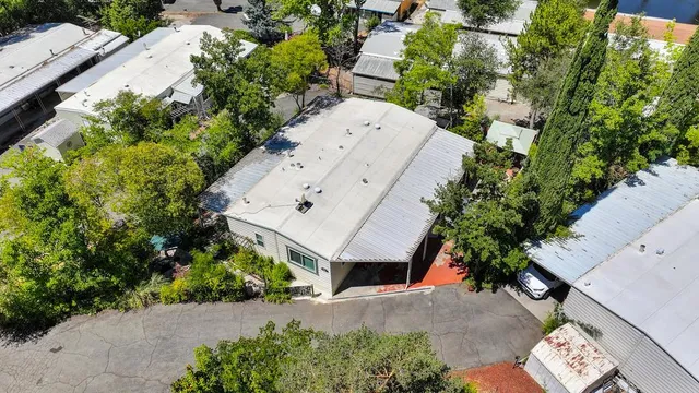an aerial view of a house with a yard and garden