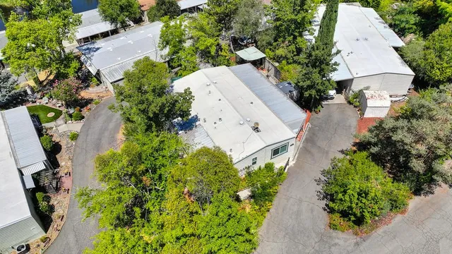 an aerial view of a house with garden space and street view