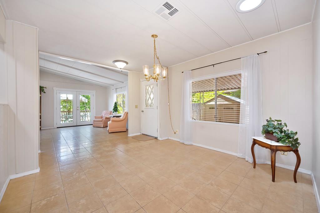 6374 Brodie Drive Newcastle, CA 95658 - Photo 9 of 50 a living room with furniture and a chandelier