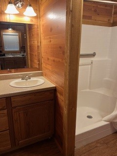 11497 Coon Hollow Road Conroe, TX 77306 - Photo 14 of 45 a bathroom with a sink a mirror and a bathtub