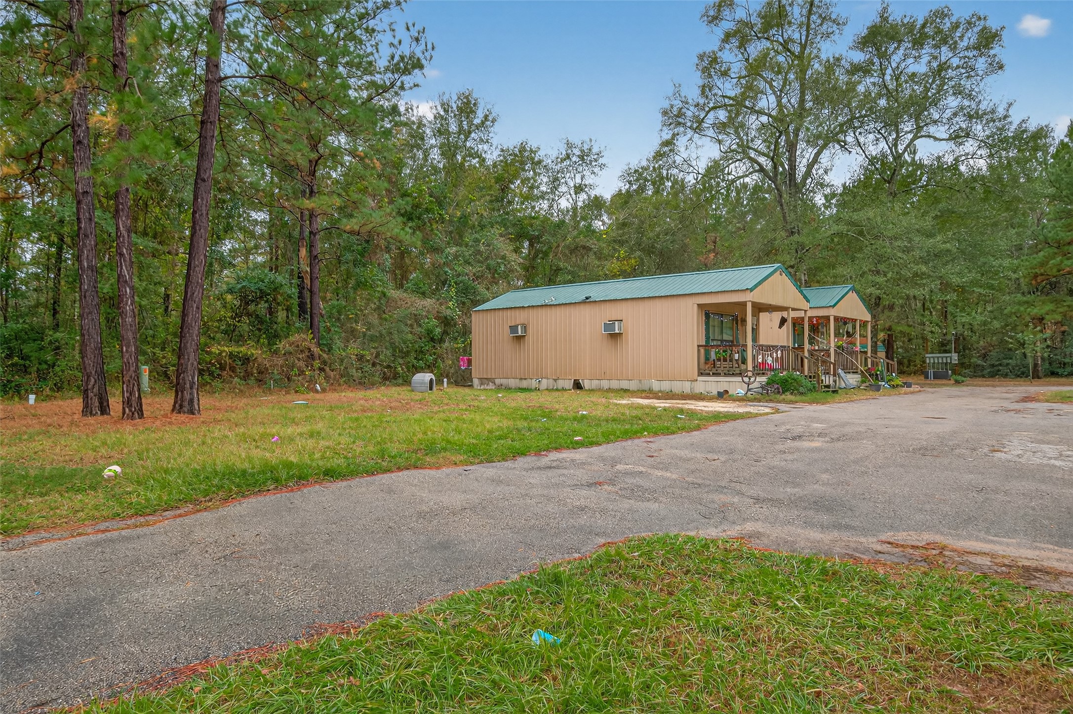 11497 Coon Hollow Road Conroe, TX 77306 - Photo 19 of 45 a house with green field in front of it