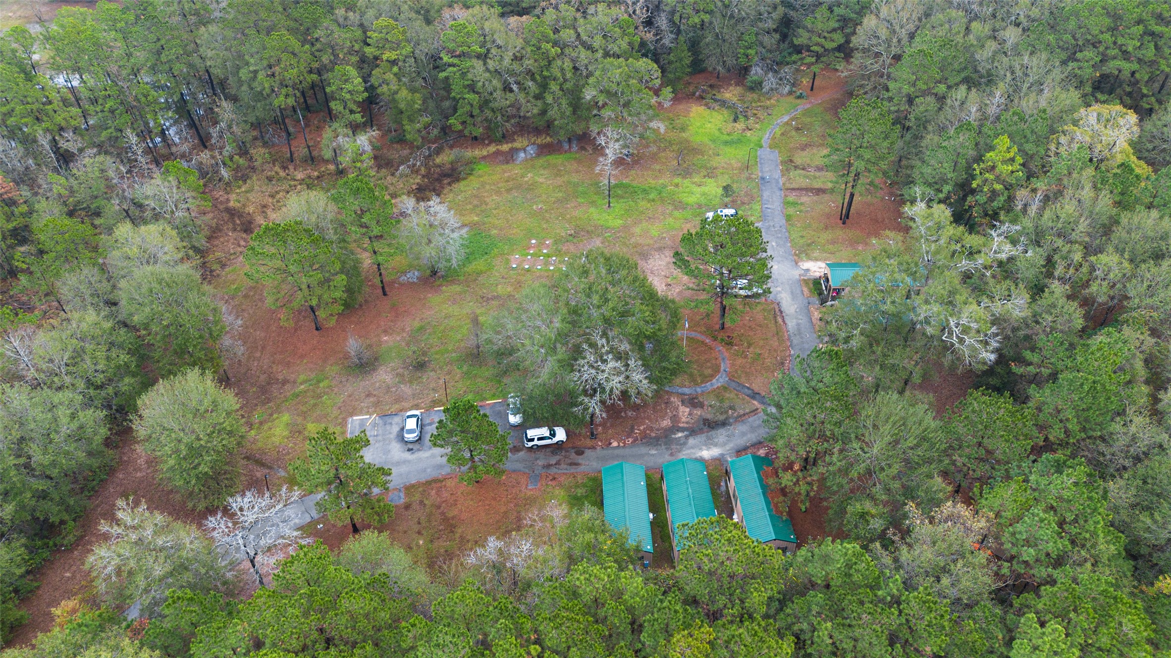 11497 Coon Hollow Road Conroe, TX 77306 - Photo 28 of 45 an aerial view of residential house with outdoor space and trees all around