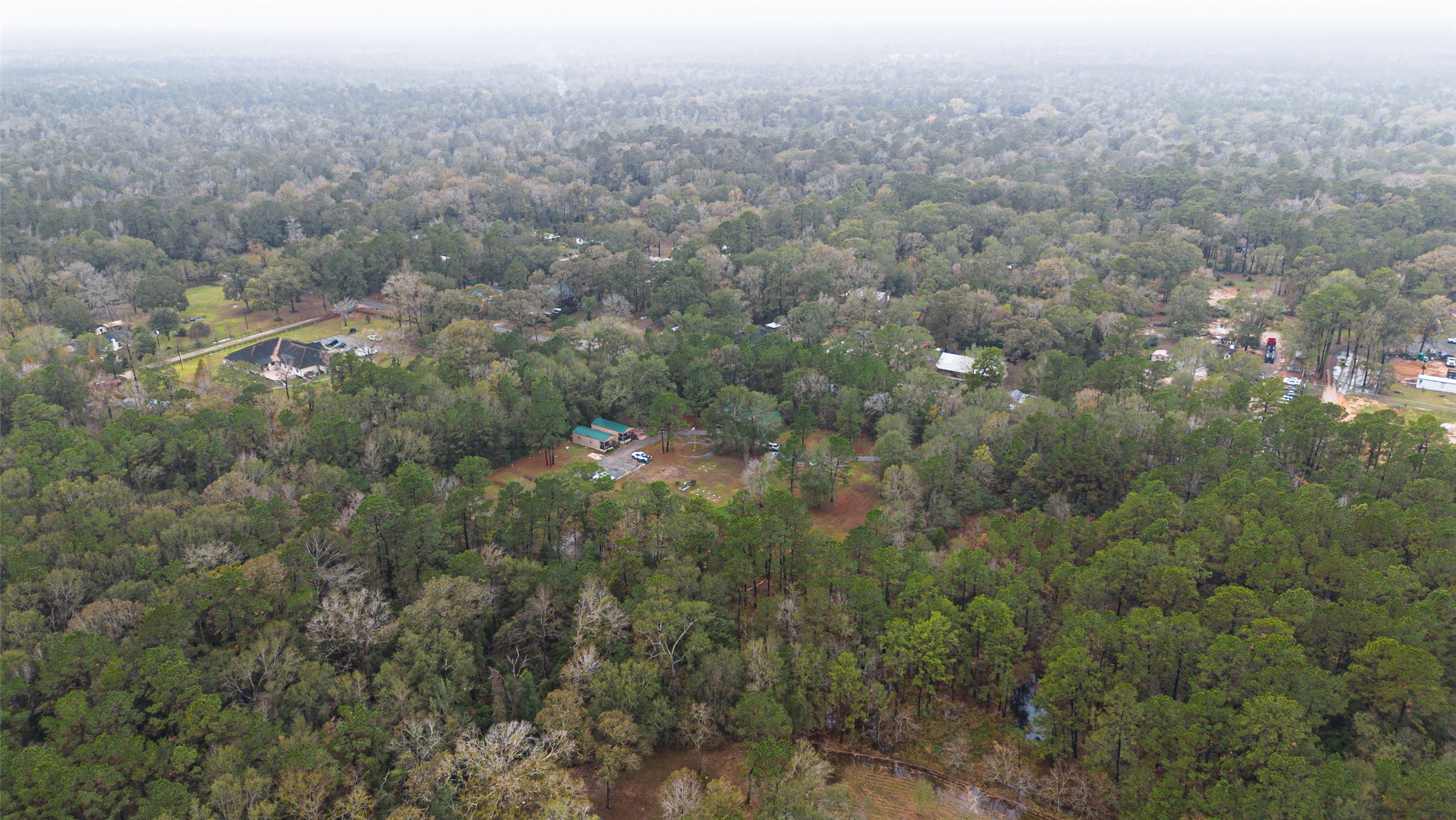 11497 Coon Hollow Road Conroe, TX 77306 - Photo 39 of 45 an aerial view of house with yard and mountain view in back