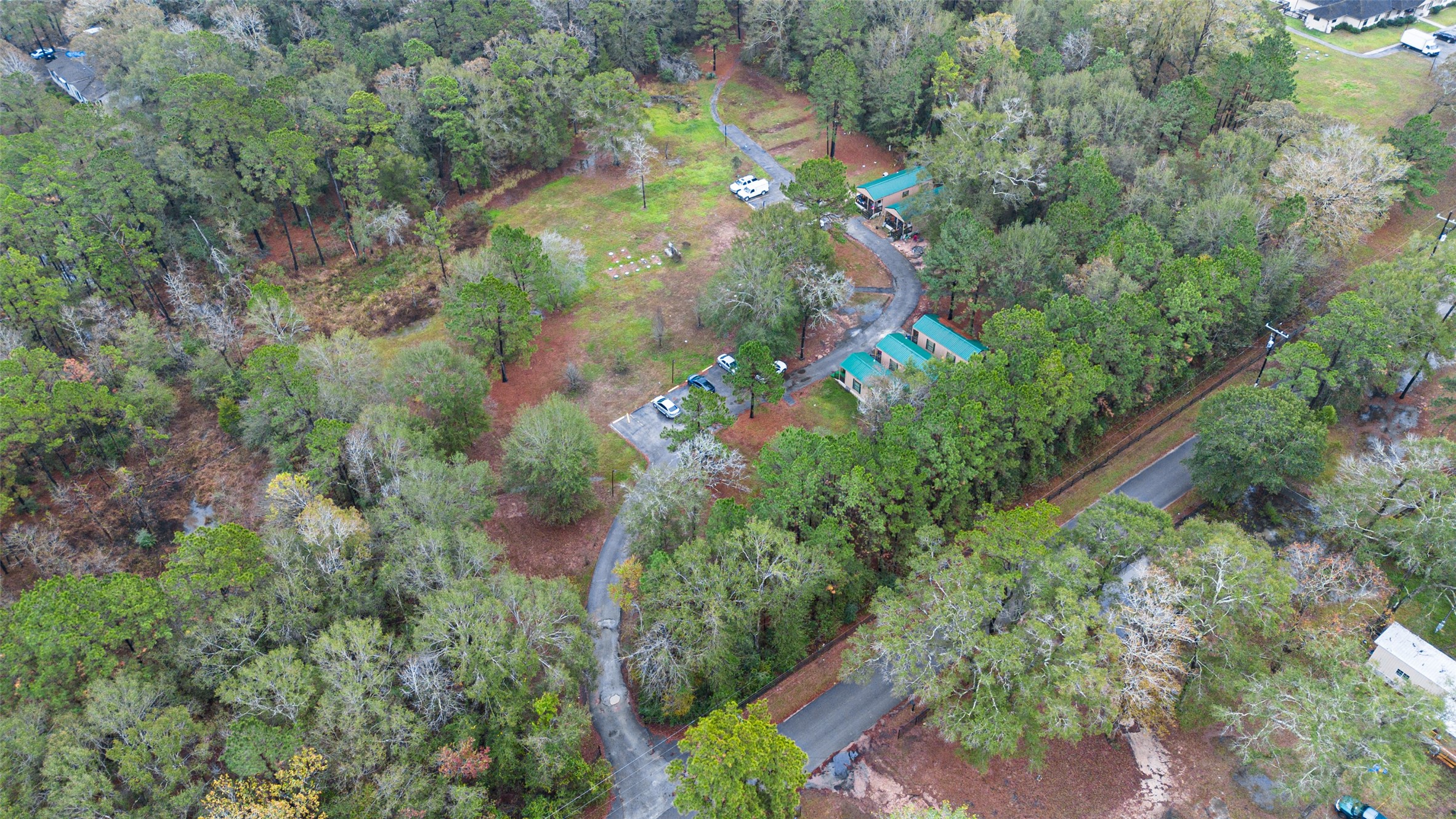 11497 Coon Hollow Road Conroe, TX 77306 - Photo 45 of 45 an aerial view of residential houses with outdoor space and trees