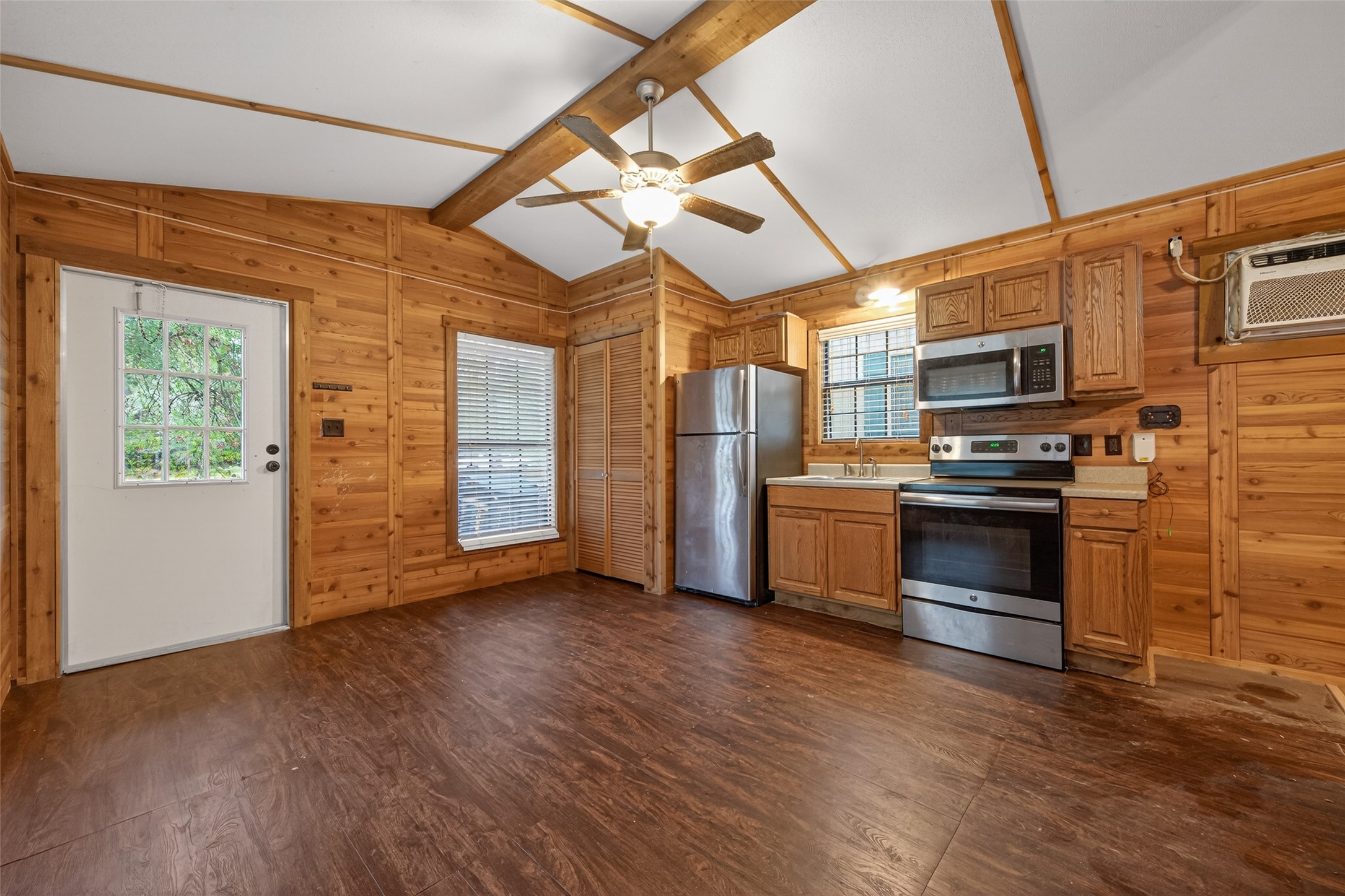 11497 Coon Hollow Road Conroe, TX 77306 - Photo 7 of 45 a kitchen with stainless steel appliances a stove a refrigerator and a microwave