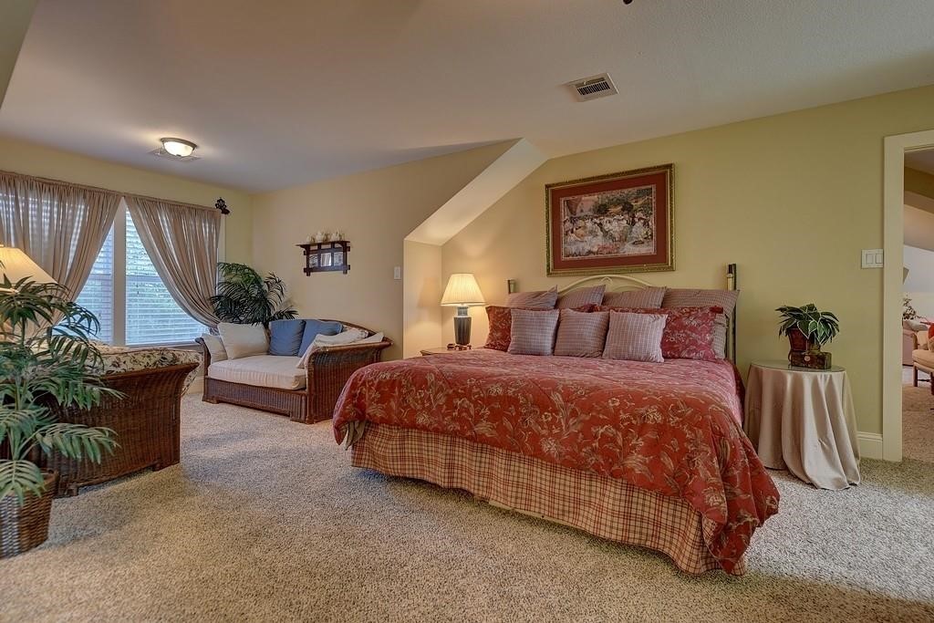8456 Schuster Road Ledbetter, TX 78946 - Photo 29 of 49 a spacious bedroom with a bed a couch and a large window