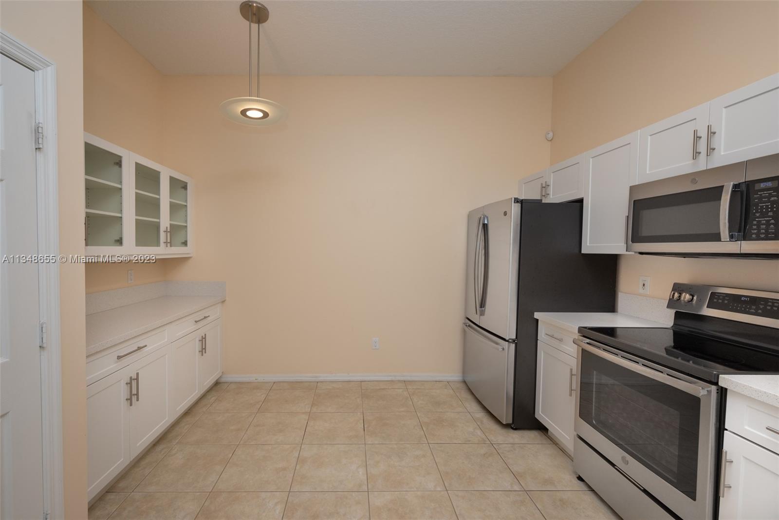 159 Coconut Key Lane Delray Beach, FL 33484 - Photo 11 of 29 a kitchen with stainless steel appliances granite countertop a refrigerator and a stove top oven