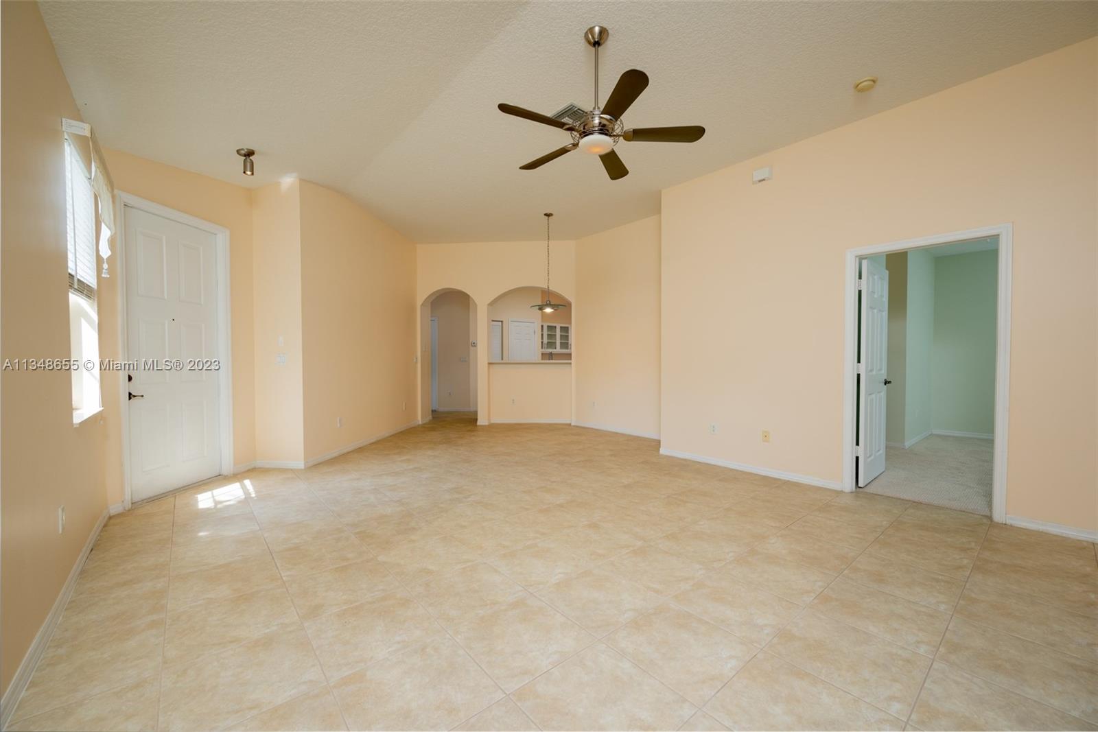 159 Coconut Key Lane Delray Beach, FL 33484 - Photo 14 of 29 a view of a livingroom with a ceiling fan and entryway