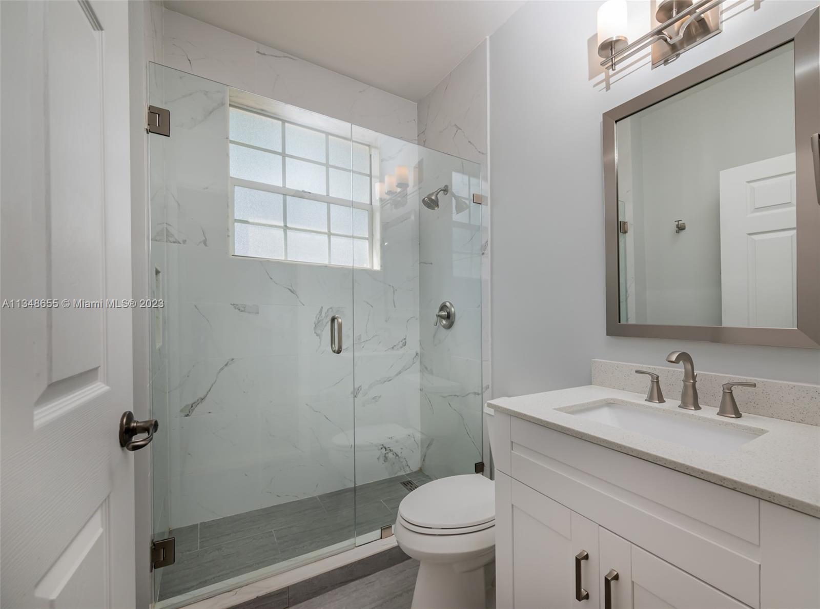 159 Coconut Key Lane Delray Beach, FL 33484 - Photo 16 of 29 a bathroom with a sink a toilet and shower