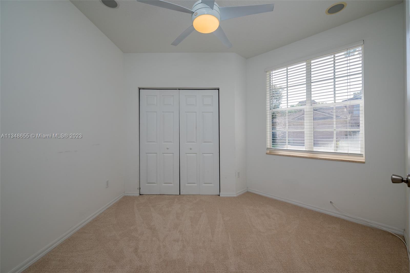 159 Coconut Key Lane Delray Beach, FL 33484 - Photo 19 of 29 an empty room with window and mirror