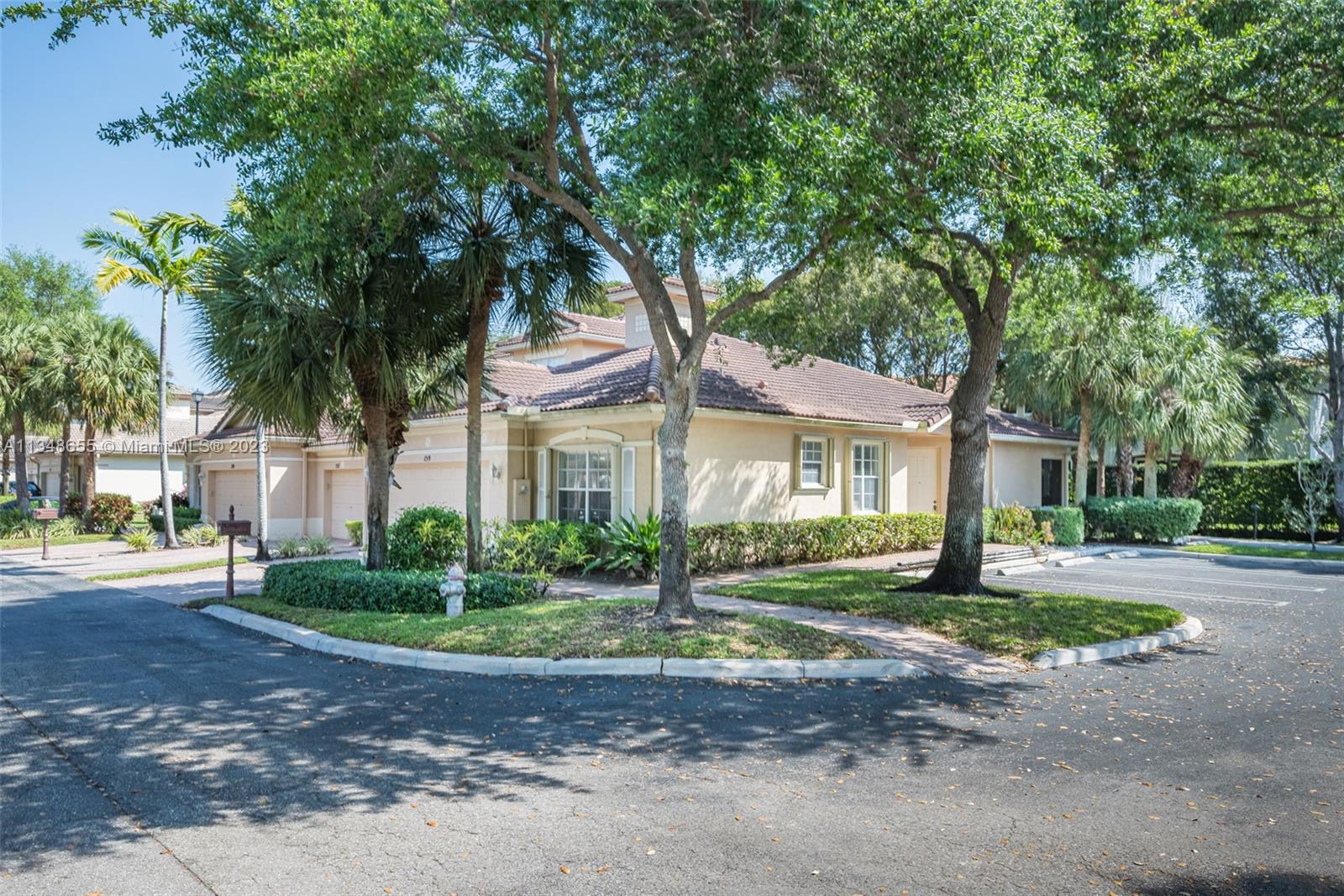 159 Coconut Key Lane Delray Beach, FL 33484 - Photo 2 of 29 a front view of a house with a yard and a garage