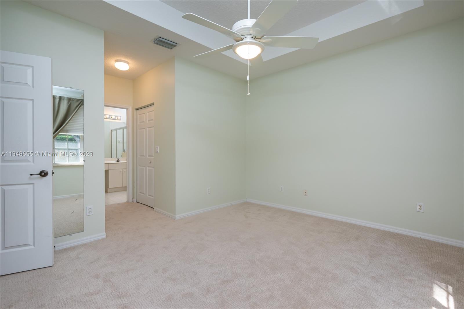 159 Coconut Key Lane Delray Beach, FL 33484 - Photo 21 of 29 wooden floor in an empty room and a fan