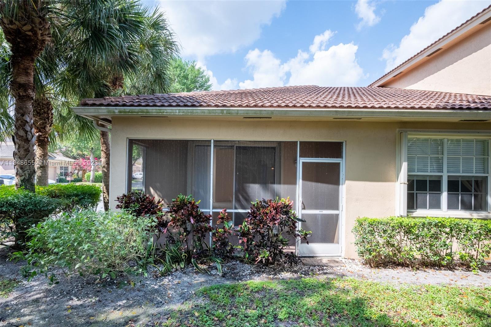 159 Coconut Key Lane Delray Beach, FL 33484 - Photo 24 of 29 a front view of a house with a large tree