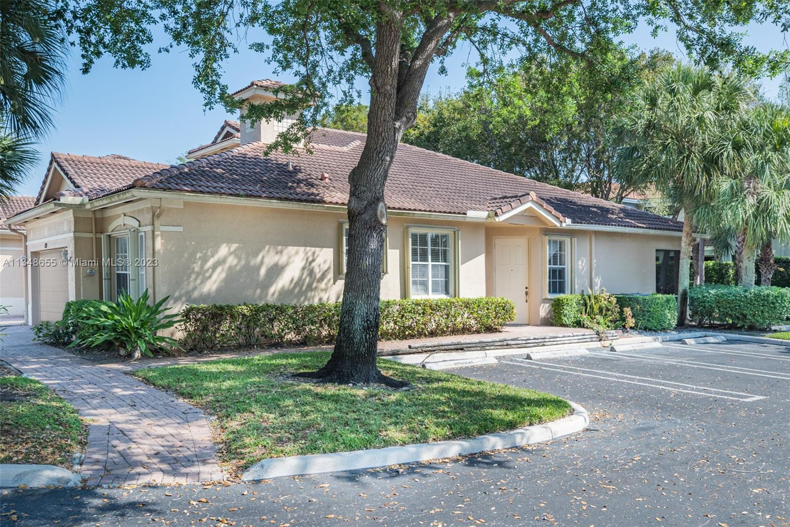 159 Coconut Key Lane Delray Beach, FL 33484 - Photo 3 of 29 a front view of a house with garden