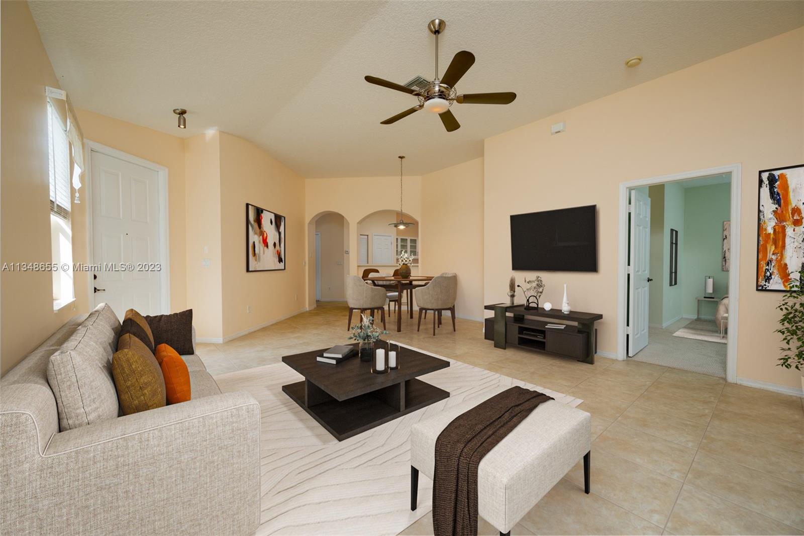 159 Coconut Key Lane Delray Beach, FL 33484 - Photo 6 of 29 a view of a livingroom with furniture and a flat screen tv