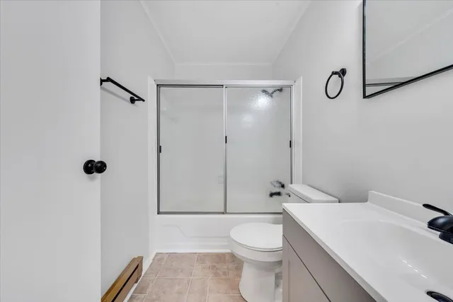 a white toilet sitting next to a bathroom sink