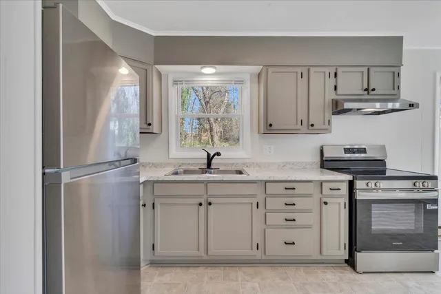 a kitchen with appliances cabinets and a sink
