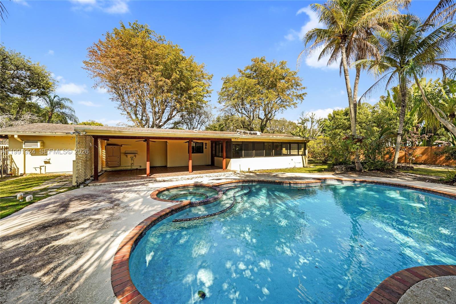8250 Southwest 95th Street Miami, FL 33156 - Photo 12 of 21 a front view of a house with swimming pool having outdoor seating