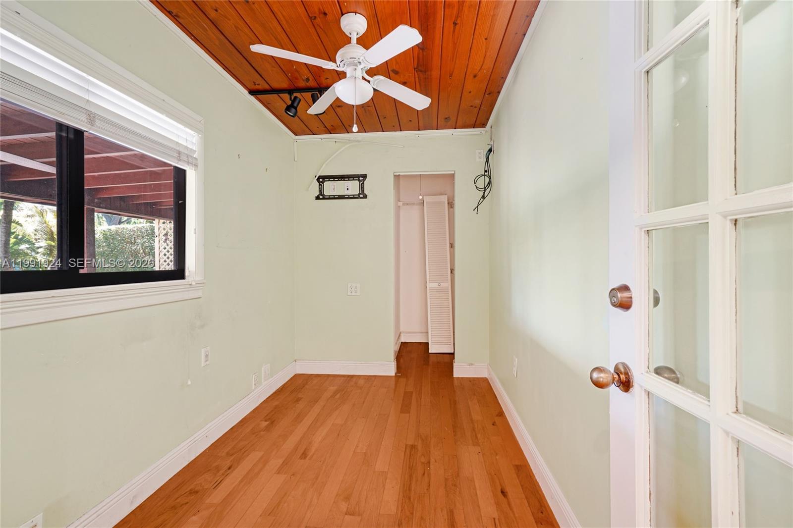 8250 Southwest 95th Street Miami, FL 33156 - Photo 14 of 21 a view of a hallway with wooden floor and a bathroom