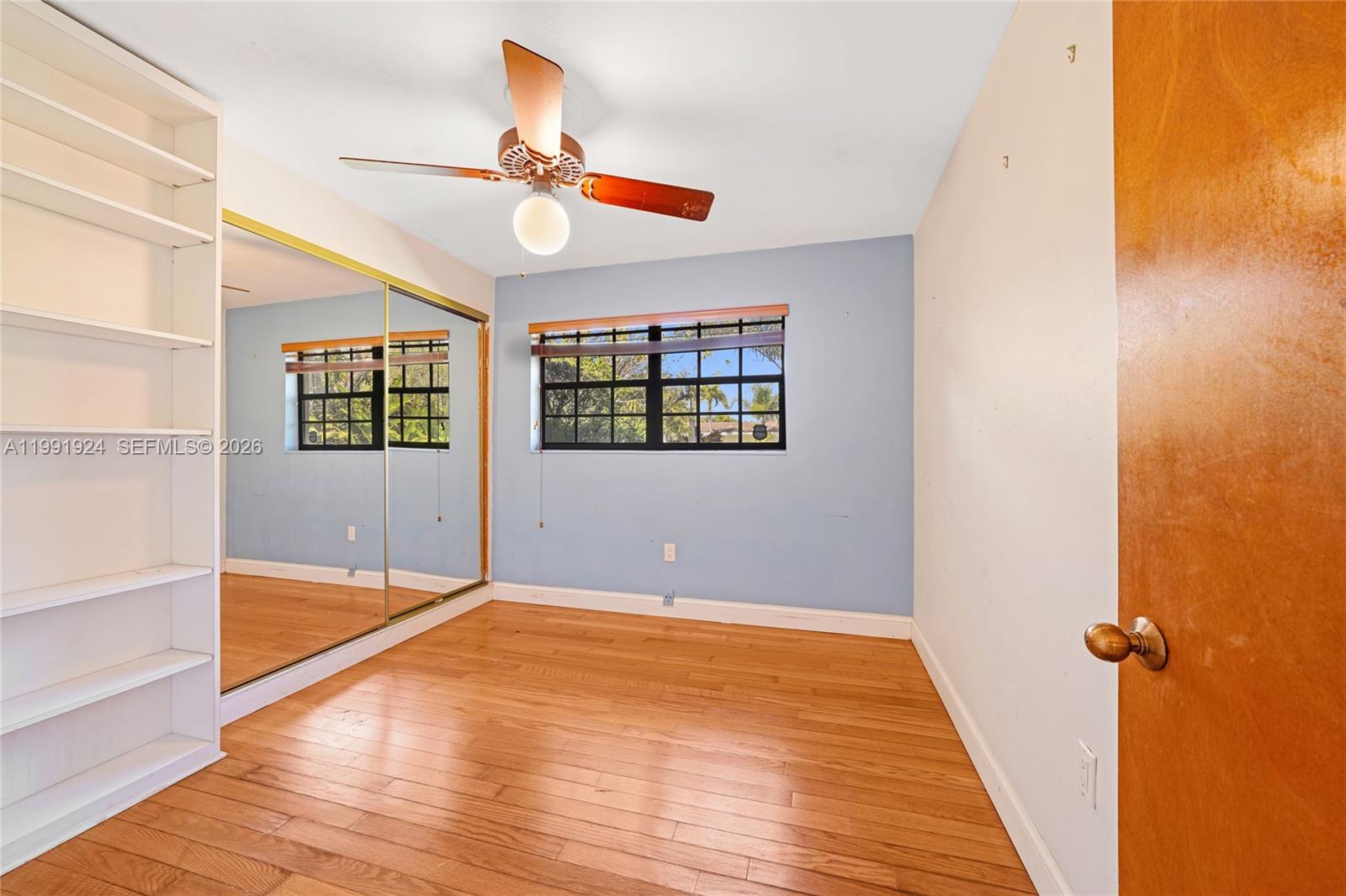 8250 Southwest 95th Street Miami, FL 33156 - Photo 16 of 21 a view of an empty room with wooden floor and a window