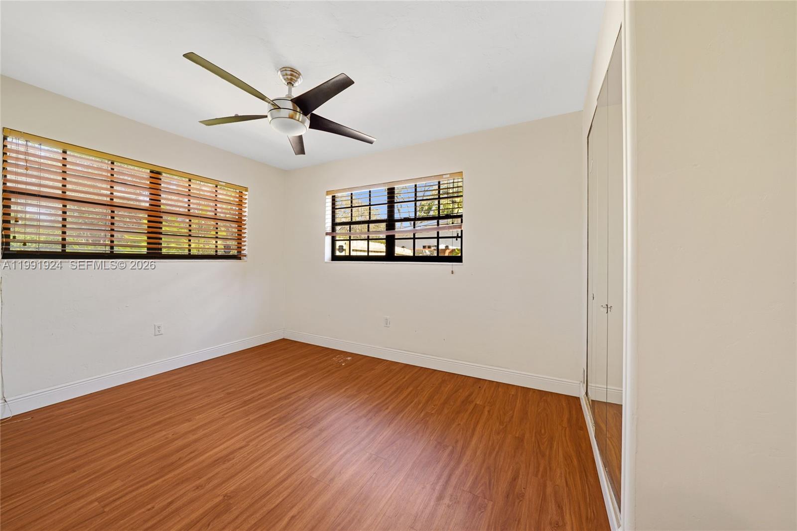 8250 Southwest 95th Street Miami, FL 33156 - Photo 17 of 21 a view of empty room with wooden floor and fan
