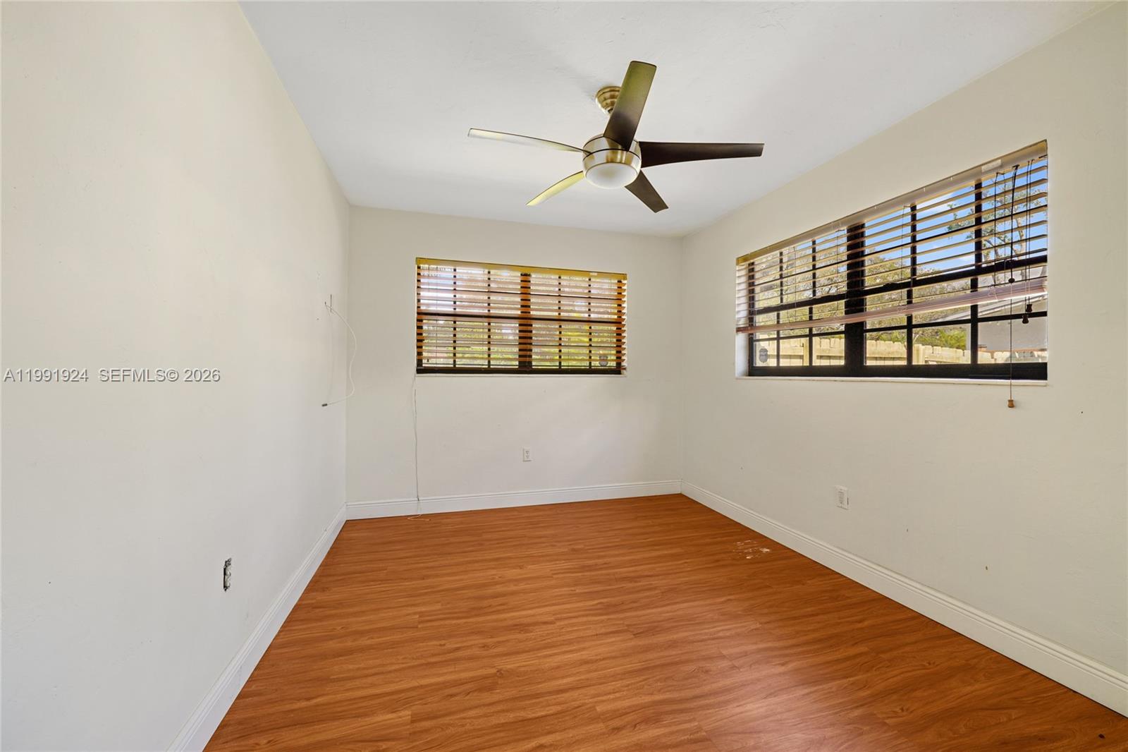 8250 Southwest 95th Street Miami, FL 33156 - Photo 18 of 21 a view of a big room with wooden floor closet and windows