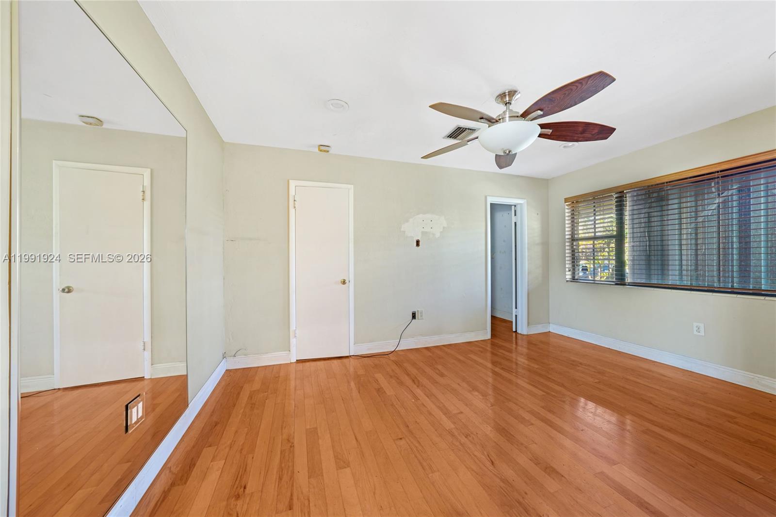 8250 Southwest 95th Street Miami, FL 33156 - Photo 6 of 21 a view of an empty room with window and wooden floor