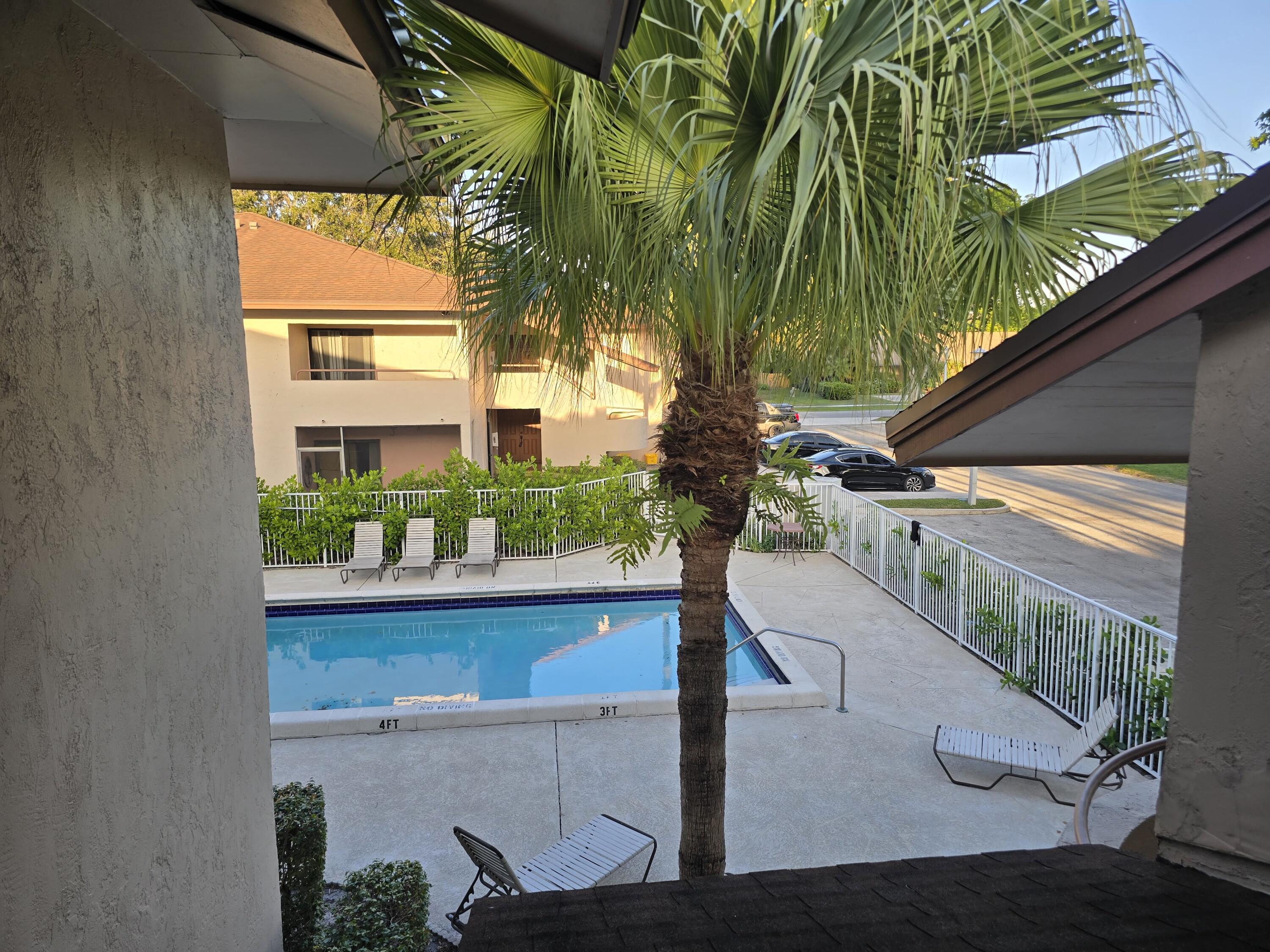 a view of balcony with furniture and garden