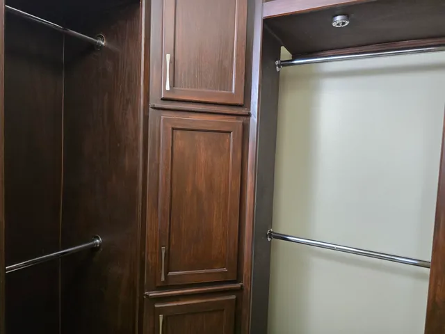 an empty room with windows ceiling fan and window