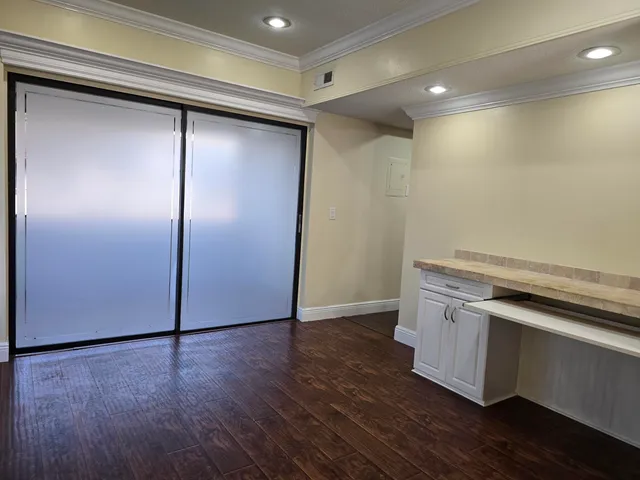 a kitchen with stainless steel appliances granite countertop a refrigerator a stove a sink and dishwasher a oven with wooden cabinets