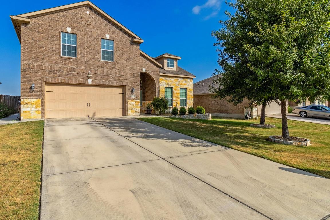a front view of a house with a yard