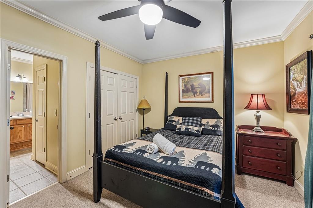 14 Laurel Ridge Lane Big Canoe, GA 30143 - Photo 51 of 72 a bedroom with a bed and a chandelier
