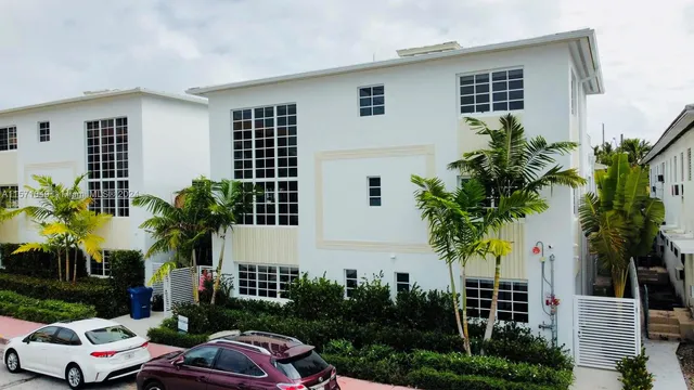 a front view of a house with plants