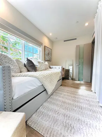 a bedroom with a bed and a couch