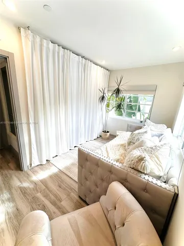 a living room with a bed and a couch