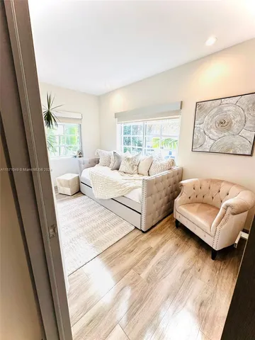 a large bedroom with a bed and a flat screen tv